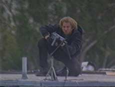 Val Kilmer rolling out of cover with the SG1